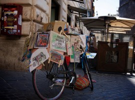 Una bicicletta romana coperta di affissioni, pannelli e volantini vari